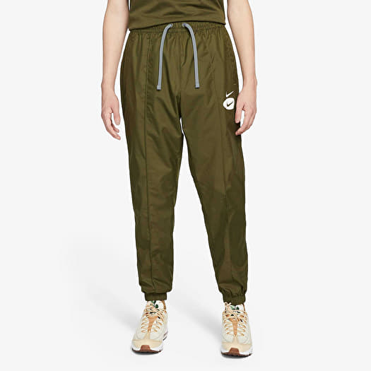Jeans en broeken Nike Sportswear Swoosh League Men s Woven Lined Pants Rough Green Queens