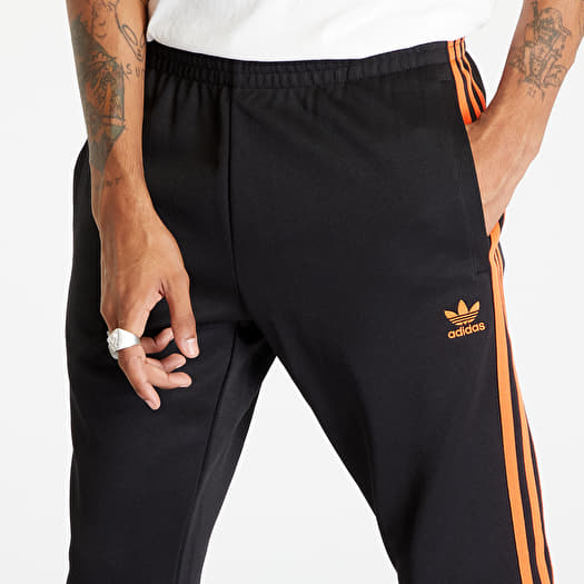 Superstar track pants orange top